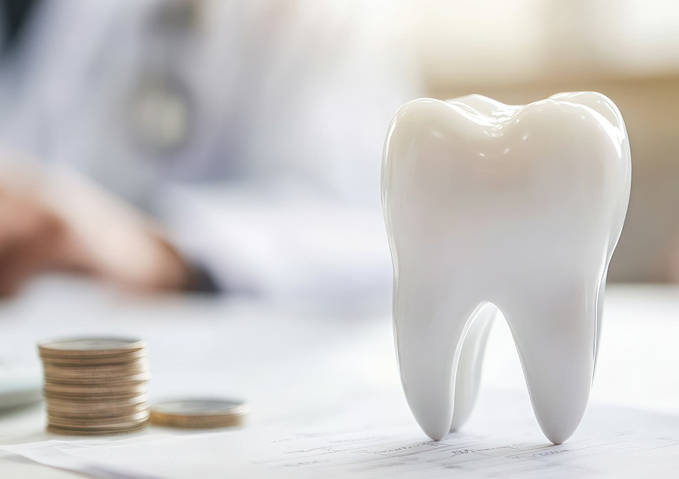 Prop tooth on paperwork next to coins