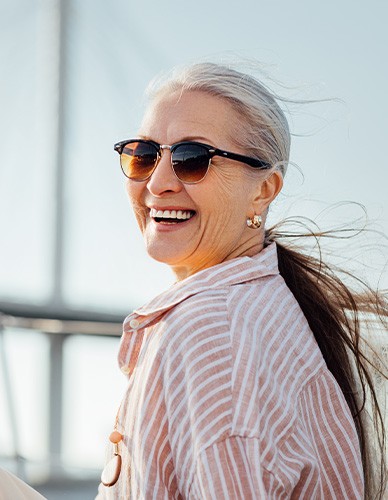 Woman with glasses smiling on boat