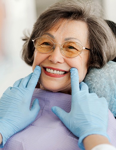 Dentist looking at smiling patient's teeth