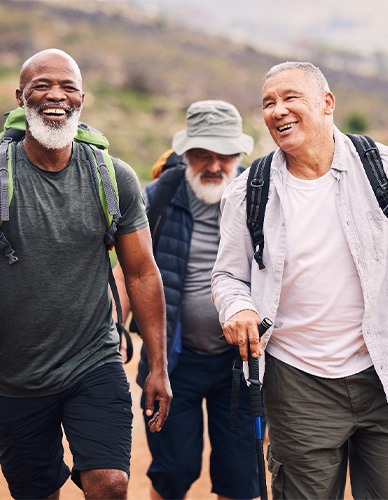 Dentures patient in Richardson smiling with friends